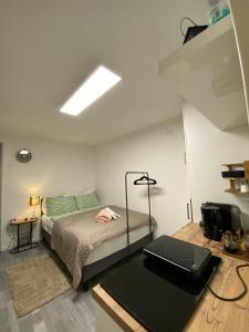 a bedroom with a bed and a laptop on a table at St Georgen im Attergau ein Zimmer Wohnung in Sankt Georgen im Attergau