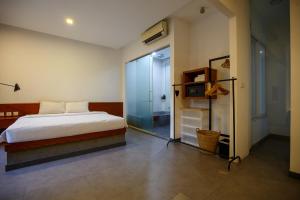 a bedroom with a bed and a sliding glass door at Cheers Social Apartment & Hotel BKK1 in Phnom Penh
