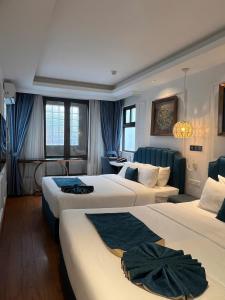 a hotel room with two beds and a room with at Hanoi Fiesta Central Hotel and Spa in Hanoi