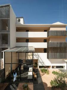 an external view of a house with a glass roof at Dali Rushi Jiuxi Sea View Holiday Inn in Dali Airport