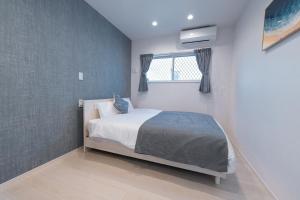 En eller flere senge i et værelse på ガーデンヴィラミヤコアネックスエー