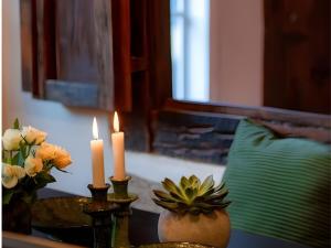 a table with two candles and flowers on it at N5Quartier in Bad Münstereifel +24 photos