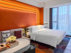 a hotel room with a large bed and a couch at Hotel Indigo Zhuhai Xiangzhou by IHG in Zhuhai +21 photos