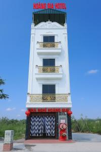 a white building with a sign on the side of it at Hoàng Gia Hotel Royal in Kim Bảng