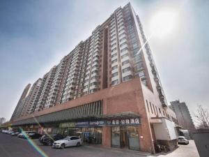 a large building with cars parked in front of it at Xana Lite Beijing West Station Branch in Beijing
