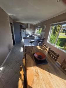 a kitchen and dining room with a wooden table at The Retreat Taupo in Taupo