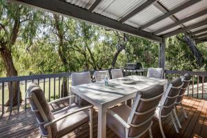 a white table and chairs on a deck at Tranquil Waters in Quindalup