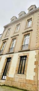 a large building with windows on the side of it at Élégance et modernité à proximité de la cathédrale in Quimper