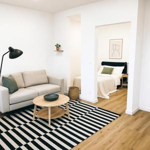 a living room with a couch and a bed at Ferienwohnung Neuwied in Neuwied