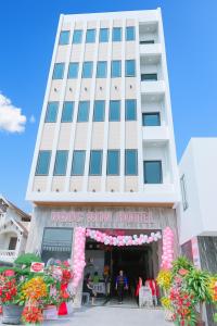 a tall building with a store in front of it at Ngọc Sơn Hotel in Hai Phong