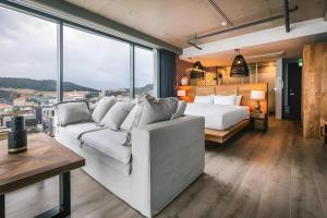 a living room with a white couch and a bed at Tropical Hideaway in Seogwipo +89 photos