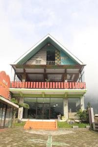 a large building with a balcony on top of it at Wong Pai Ton Villa in Ngadisari