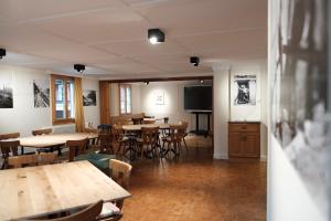 een eetkamer met tafels en stoelen en een flatscreen-tv bij DASCO Isenthal in Isenthal +9 foto's