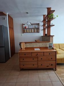 a living room with a dresser and a couch at Centrum apartman in Szekszárd