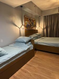 two beds in a room with two lamps at CAROLA in Pico de Loro in Nasugbu