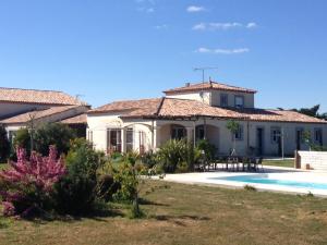 una casa con piscina frente a ella en Chambres d'hotes Deluxe Jacuzzi Mas de l'Etoile, en Aigues-Mortes