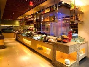 a kitchen with a counter with food on it at Ramada by Wyndham Zibo in Zibo