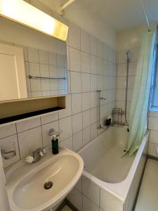 un bagno con lavandino e vasca da bagno di Simple Apartment with Essentials a Zurigo