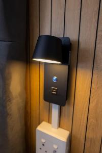 a light plugged into a wall with a plug at Towny Lodge in Kokstad