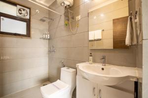 a bathroom with a sink and a toilet at BedChambers Serviced Apartment, Medicity in Gurgaon +21 photos