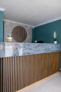 a bar in a room with a blue wall at Towny Lodge in Kokstad