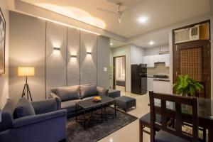 a living room with a couch and a table at BedChambers Serviced Apartment, Medicity in Gurgaon