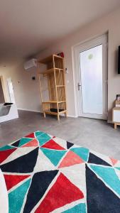 a room with a colorful rug on the floor at Maison MUGUET 2 SPA-PARKING-COLMAR in Wickerschwihr +42 photos