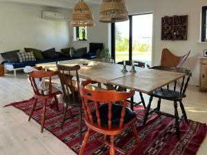 a living room with a wooden table and chairs at Sommerhus Med Udsigt Over Dalbybugten in Mesinge