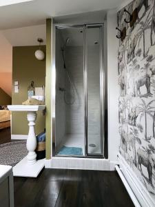 a bathroom with a shower with a glass door at Le Clos de la Chapelle Bayeux in Bayeux +60 photos