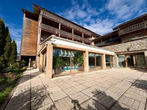 an exterior view of a building with a patio at Appartement cosy T2 Duplex in Bolquere Pyrenees 2000