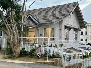 a white house with a white fence at BB House Villa in Da Thanh