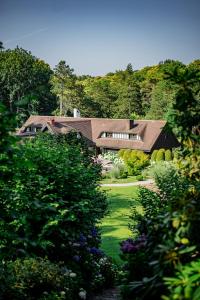 a large house in the middle of a garden at Les Pins de César - La campagne d'Etretat in Saint-Jouin-Bruneval