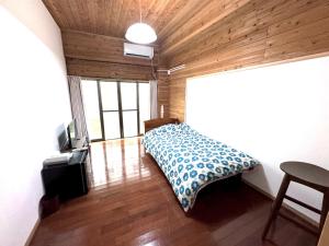 Postel nebo postele na pokoji v ubytování 徳之島体験お宿結屋