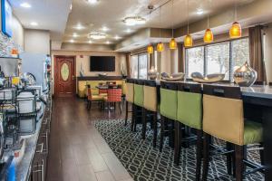 a bar in a restaurant with green chairs at Comfort Inn Blue Ash North in Blue Ash