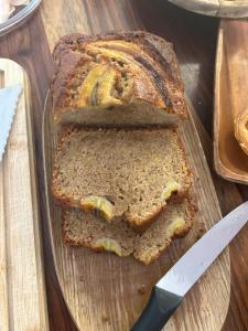 a loaf of bread on a cutting board with a knife at MAR VERDE - Parede-Cascais in Parede