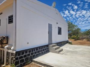 a white building with stairs on the side of it at Villa Tahina in Ramena