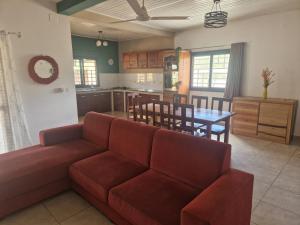 a living room with a couch and a table at Villa Tahina in Ramena