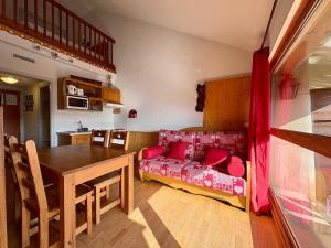 a living room with a couch and a table at Appartement cosy T2 Duplex in Bolquere Pyrenees 2000