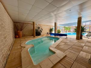 a large swimming pool in a building with a swimming pool at Appartement cosy T2 Duplex in Bolquere Pyrenees 2000 +3 photos