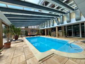 a swimming pool in a building with awning at Appartement cosy T2 Duplex in Bolquere Pyrenees 2000