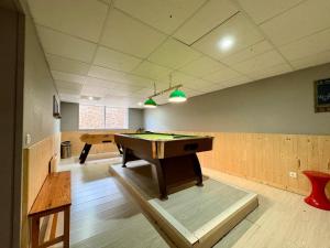 a ping pong table in a room with two tables at Appartement cosy T2 Duplex in Bolquere Pyrenees 2000