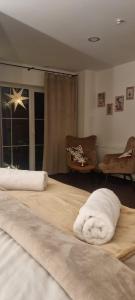 a bedroom with two beds with white towels on them at Penzion Branná in Branná