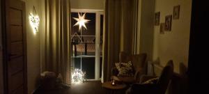 a living room with a christmas tree in a window at Penzion Branná in Branná +1 photo