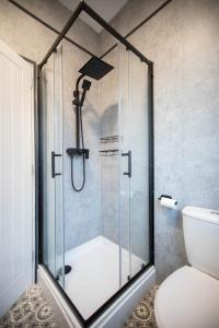 a shower with a glass door in a bathroom at Comfortable Stay with Free Parking in Carlisle +14 photos