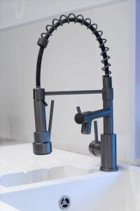 a kitchen sink with a black faucet at Comfortable Stay with Free Parking in Carlisle
