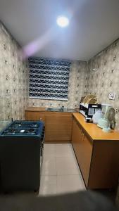 a kitchen with a stove and a counter top at OA luxury apartment 