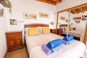 a bedroom with two beds and a mirror at Villa La Maja Beachfront in Corralejo