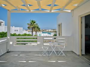 a balcony with a table and a view of the ocean at Villa Maria Naoussa in Naousa