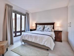 a bedroom with a bed and a large window at Manhattan Estates - Plettenberg Bay in Plettenberg Bay