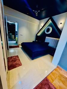 a bedroom with a blue bed in a room at Khokhar studio in Karnal